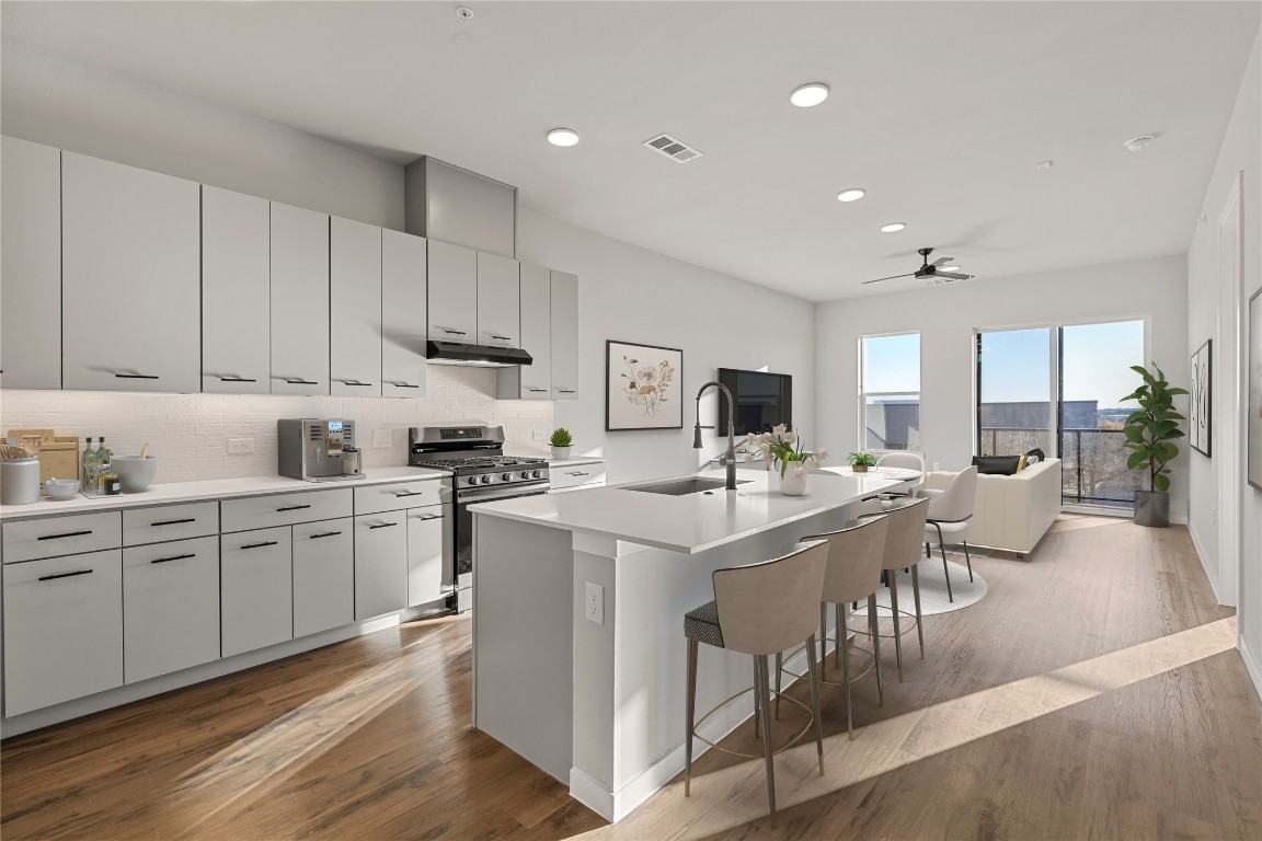 a kitchen with counter top space appliances and cabinets