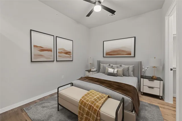 a bedroom with a bed and a painting on the wall