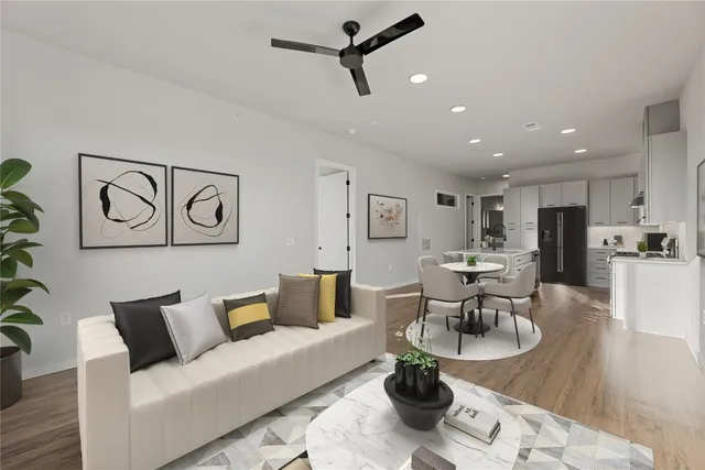a living room with furniture and kitchen view
