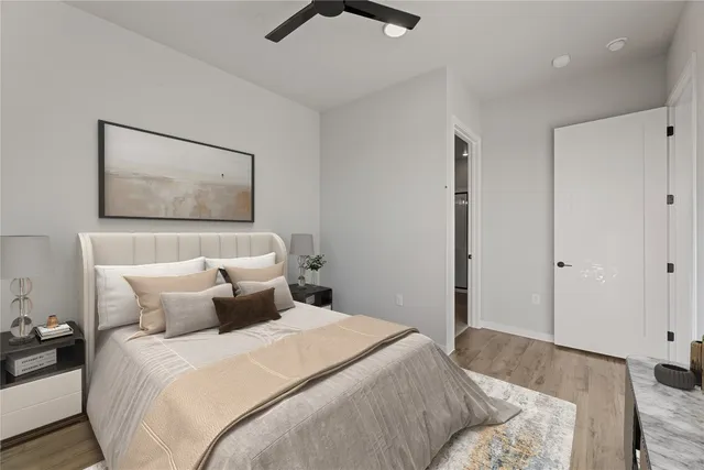 a bedroom with a bed and a painting on the wall