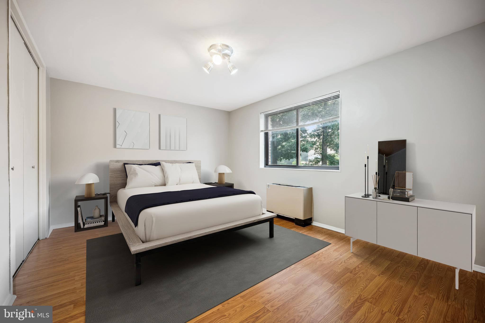 8601 Manchester Road, Unit 319 Silver Spring, MD 20901 - Photo 14 of 70 a bedroom with a bed and a flat screen tv