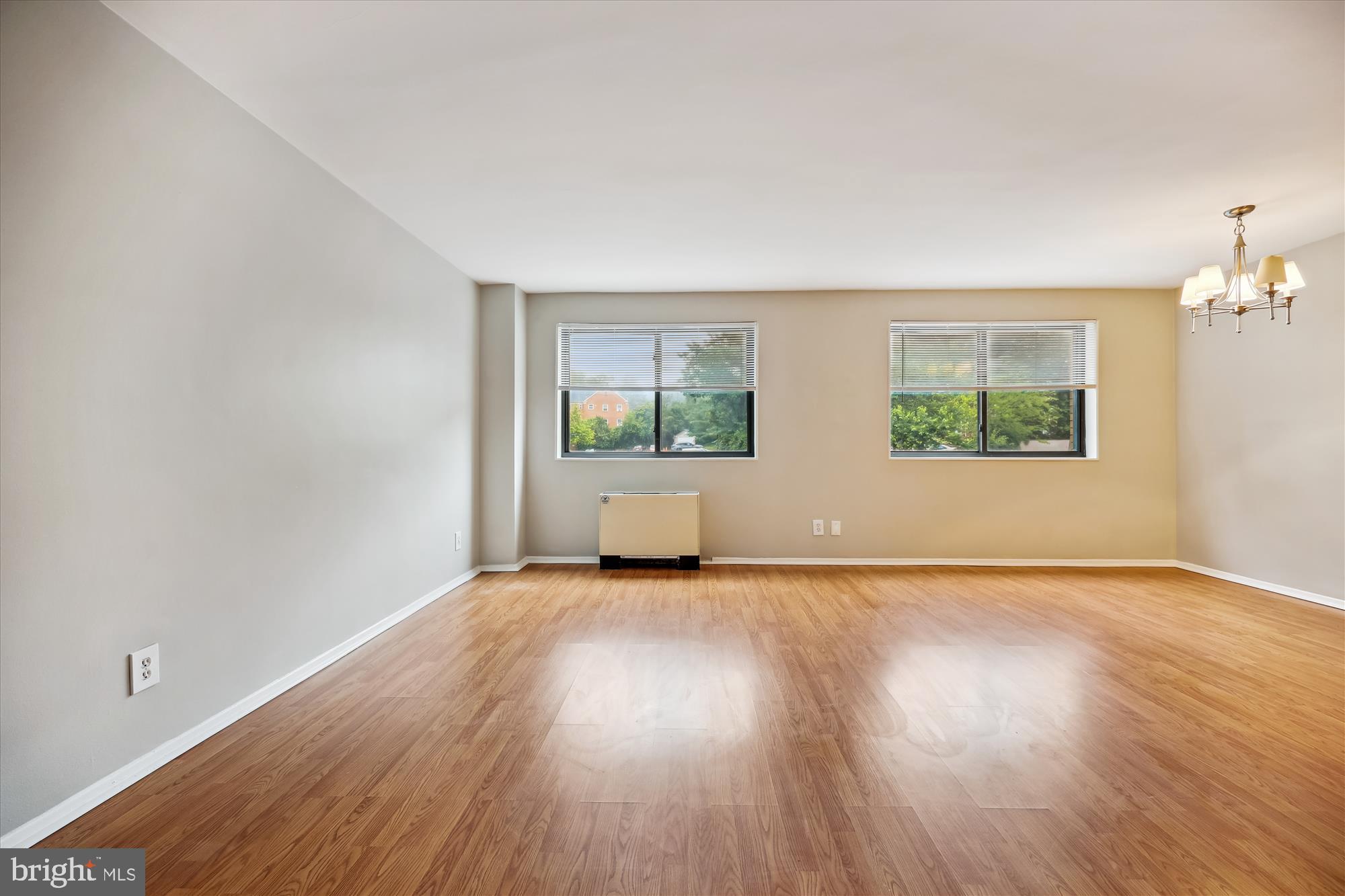 8601 Manchester Road, Unit 319 Silver Spring, MD 20901 - Photo 18 of 70 an empty room with wooden floor and windows