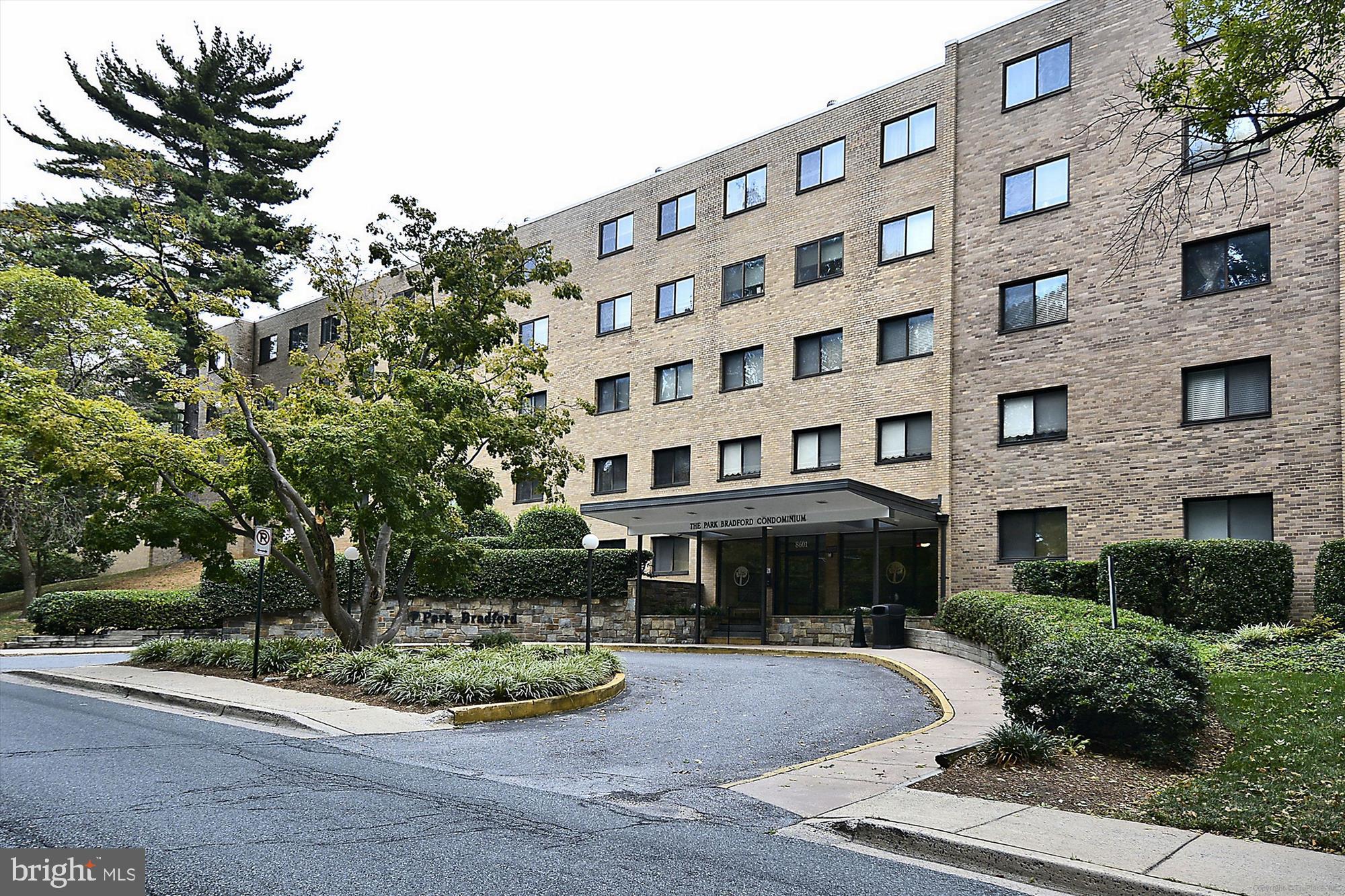 8601 Manchester Road, Unit 319 Silver Spring, MD 20901 - Photo 23 of 70 a front view of a building with garden and trees