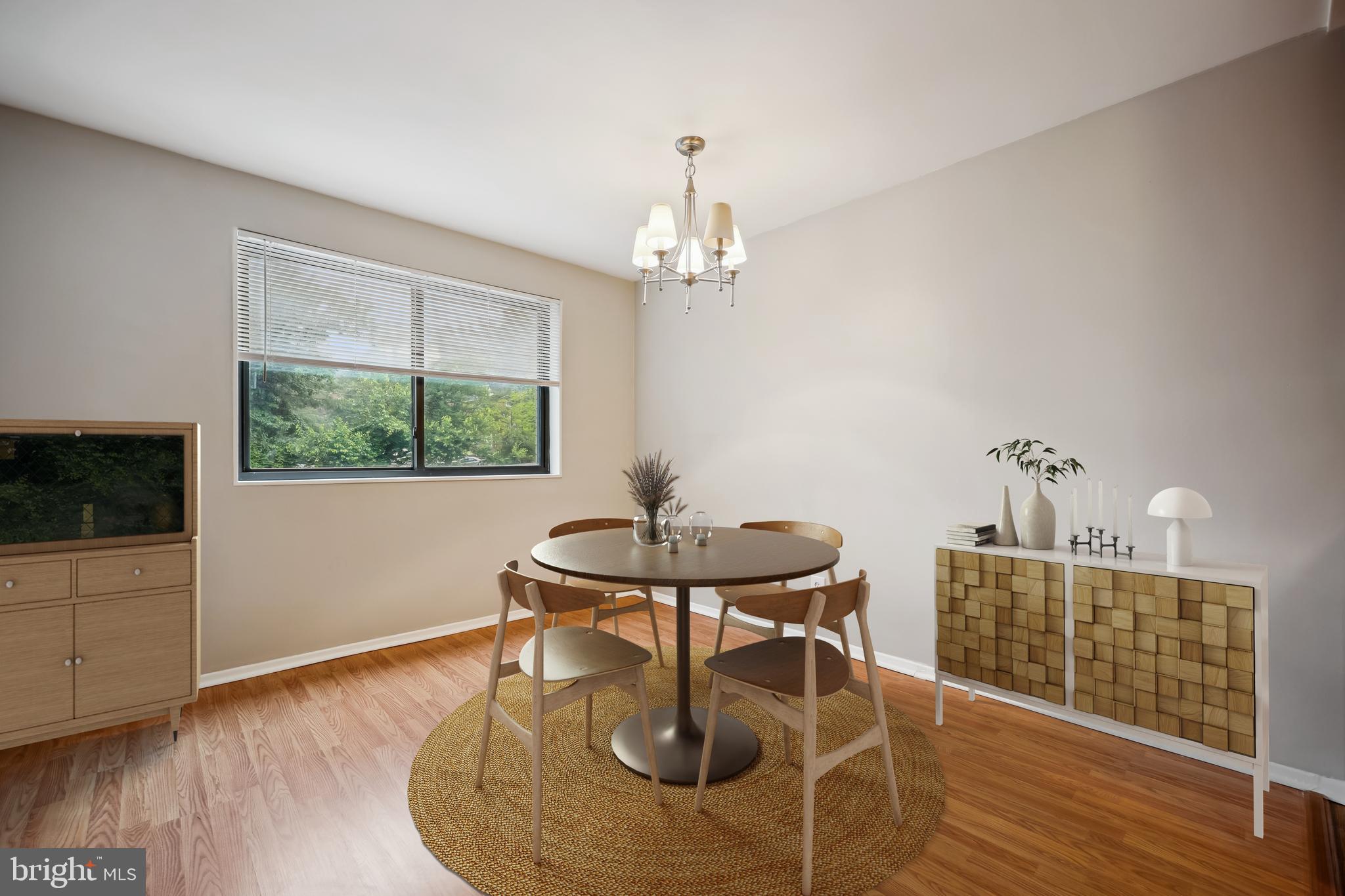 8601 Manchester Road, Unit 319 Silver Spring, MD 20901 - Photo 6 of 70 a dining room with wooden floor a chandelier a wooden table and chairs