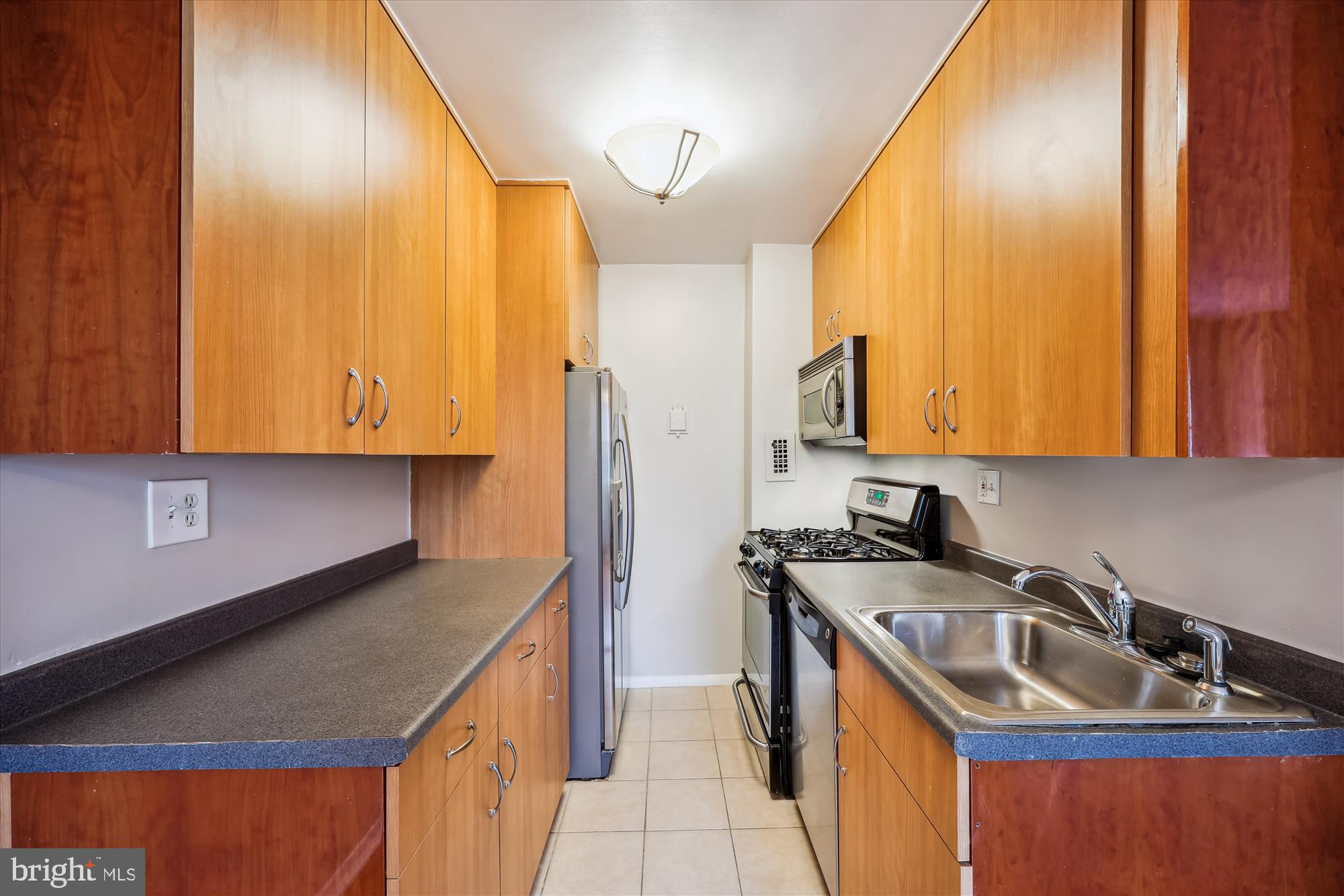 8601 Manchester Road, Unit 319 Silver Spring, MD 20901 - Photo 10 of 70 a kitchen with a sink a stove and cabinets