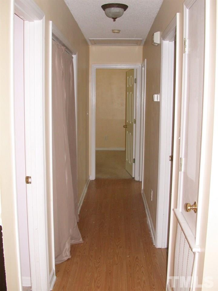 2124 Ruddy Road Raleigh, NC 27616 - Photo 15 of 20 a view of a hallway with wooden floor