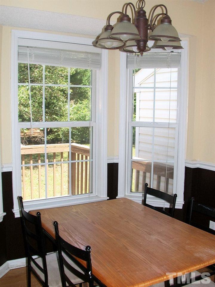 2124 Ruddy Road Raleigh, NC 27616 - Photo 5 of 20 a bedroom with a bed and a chandelier