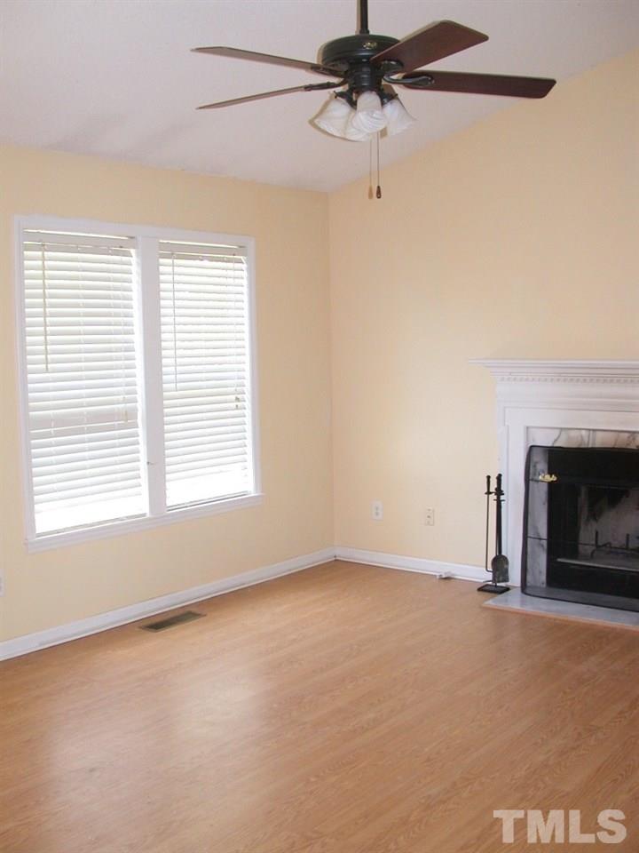 2124 Ruddy Road Raleigh, NC 27616 - Photo 6 of 20 an empty room with windows and fireplace
