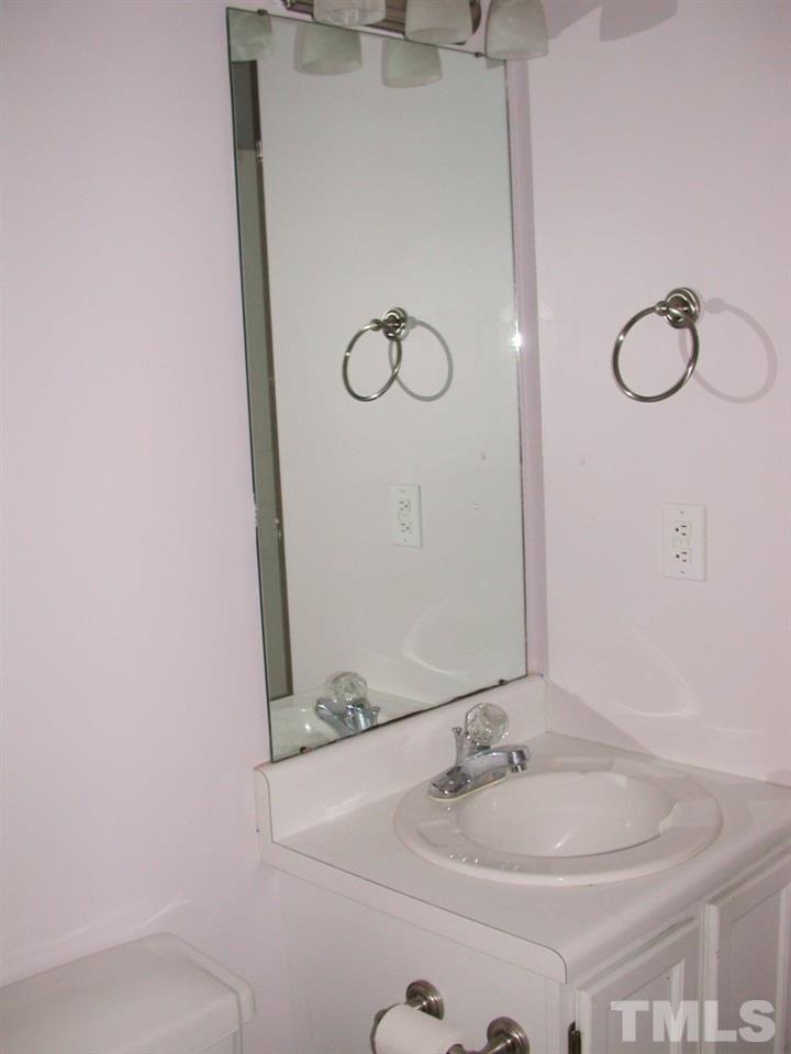 2124 Ruddy Road Raleigh, NC 27616 - Photo 10 of 20 a bathroom with a sink and a mirror