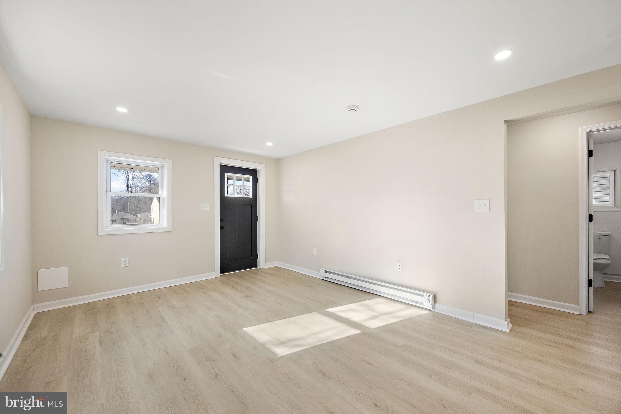 2109 Ferncroft Avenue Upper Chichester, PA 19061 - Photo 11 of 25 an empty room with wooden floor and windows