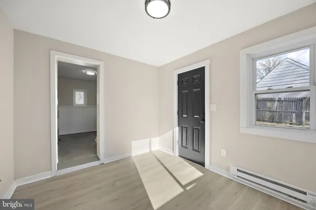 an empty room with windows and entrance