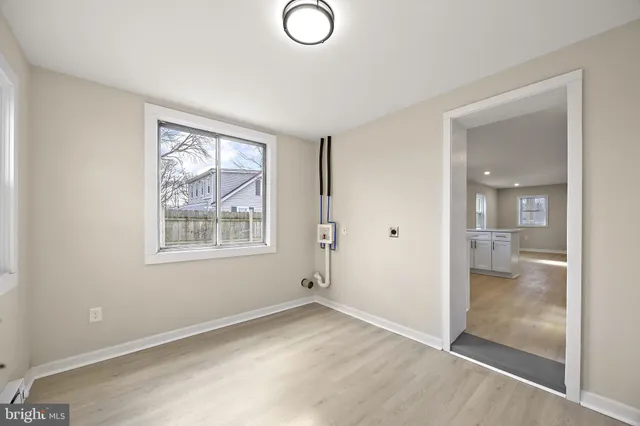 an empty room with windows and closet