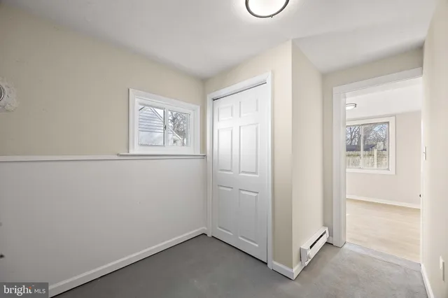 a view of a white house with a yard