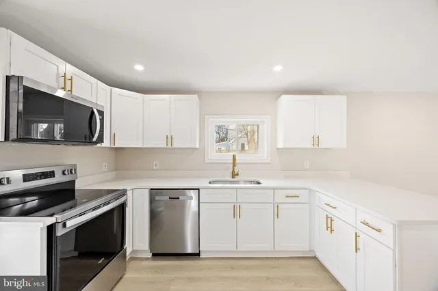 a kitchen with a sink stove and microwave