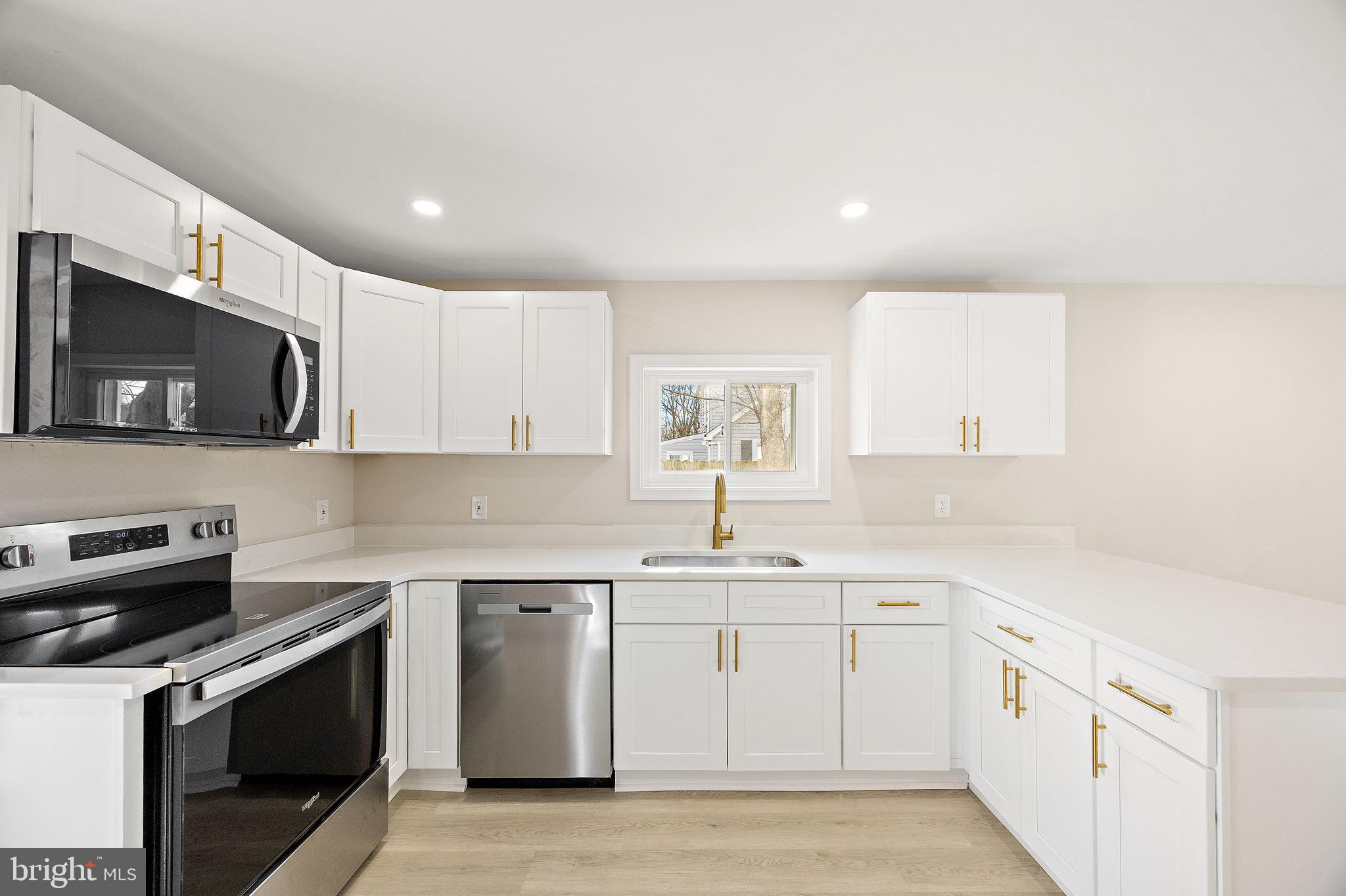 2109 Ferncroft Avenue Upper Chichester, PA 19061 - Photo 2 of 25 a kitchen with a sink stove and microwave