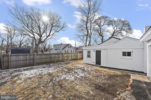 a view of a house with a door and wooden walls