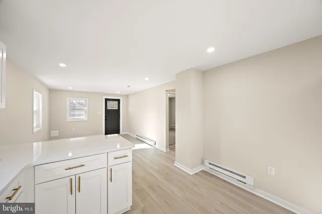 a view of kitchen with stainless steel appliances cabinets and wooden floor
