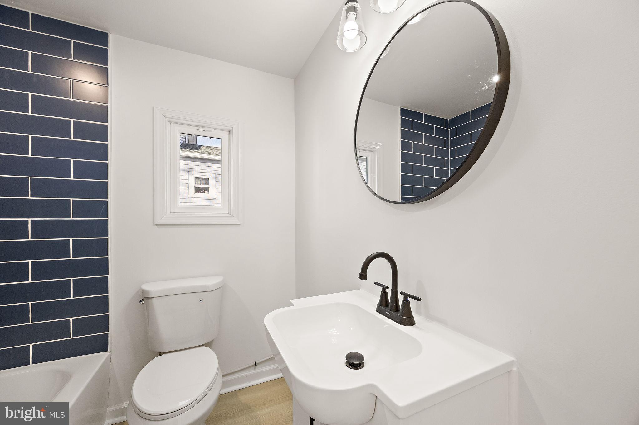 2109 Ferncroft Avenue Upper Chichester, PA 19061 - Photo 8 of 25 a bathroom with a toilet sink and mirror