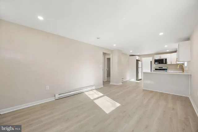 a view of kitchen with refrigerator and window