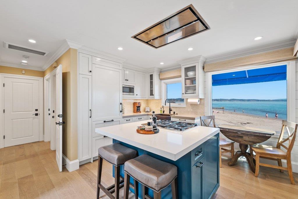 1500 Wharf Road, Unit 22 Capitola, CA 95010 - Photo 17 of 48 a white kitchen with a table and chairs in it