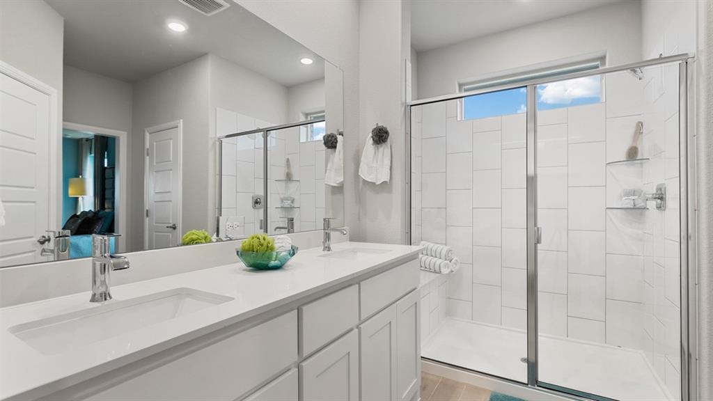 717 Bushman Drive Aledo, TX 76008 - Photo 17 of 40 a bathroom with a double vanity sink and shower