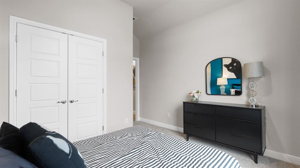 717 Bushman Drive Aledo, TX 76008 - Photo 23 of 40 a bedroom with a bed and a dresser