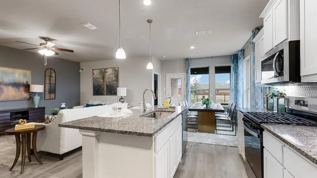 a kitchen with stainless steel appliances a refrigerator sink and stove