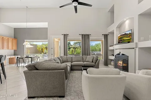 a kitchen with granite countertop a table chairs stove and cabinets