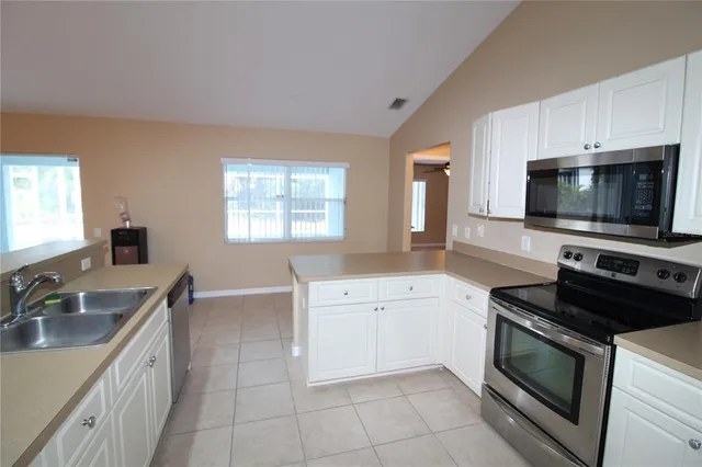 a kitchen with a sink stove and microwave