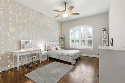 a spacious bedroom with bed and a window