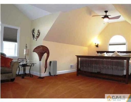 150 Emley's Hill Road Cream Ridge, NJ 08514 - Photo 11 of 11 a bedroom with a bed a chair and a fireplace