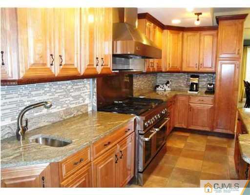 150 Emley's Hill Road Cream Ridge, NJ 08514 - Photo 3 of 11 a kitchen with granite countertop a stove and a sink