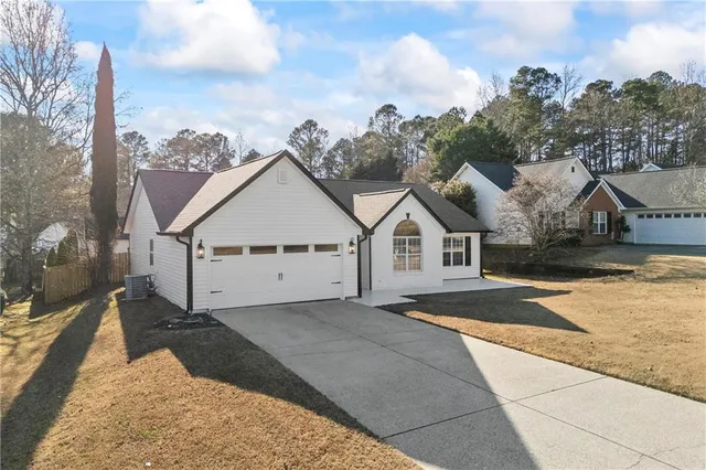 a view of a kitchen with stainless steel appliances refrigerator a stove top oven with wooden floor
