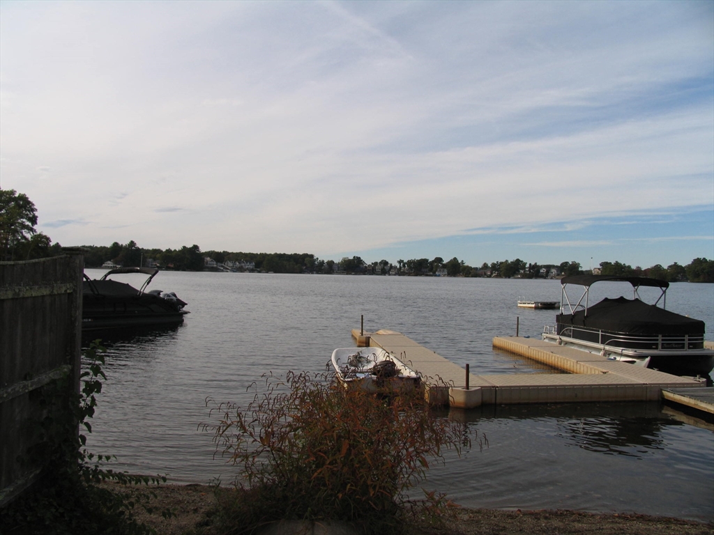11 Black Point Road Webster, MA 01570 - Photo 27 of 28 a view of a lake with lawn chairs