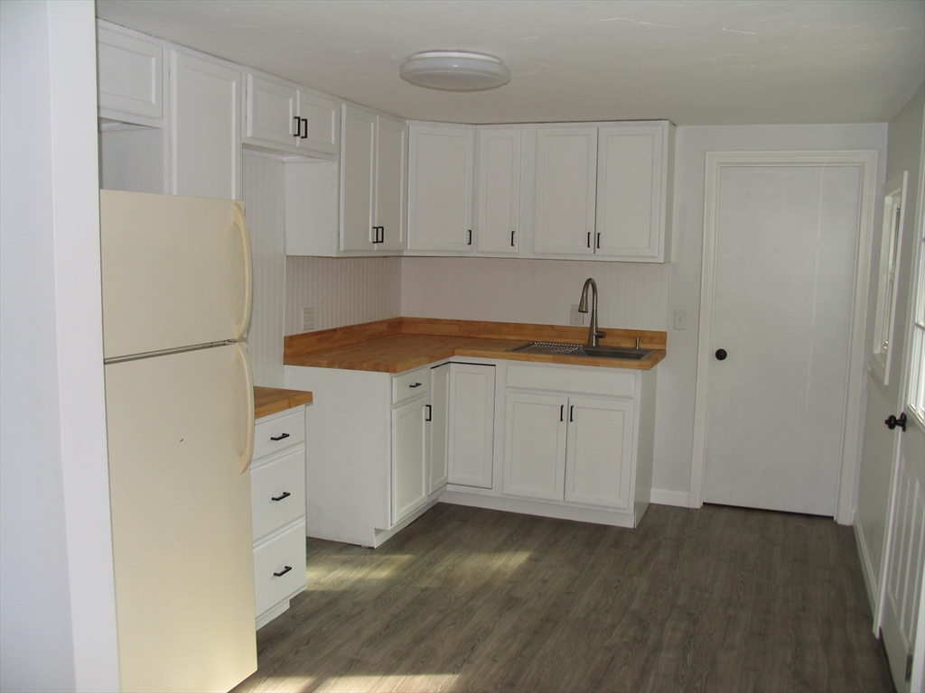 11 Black Point Road Webster, MA 01570 - Photo 8 of 28 a kitchen with white cabinets and a sink