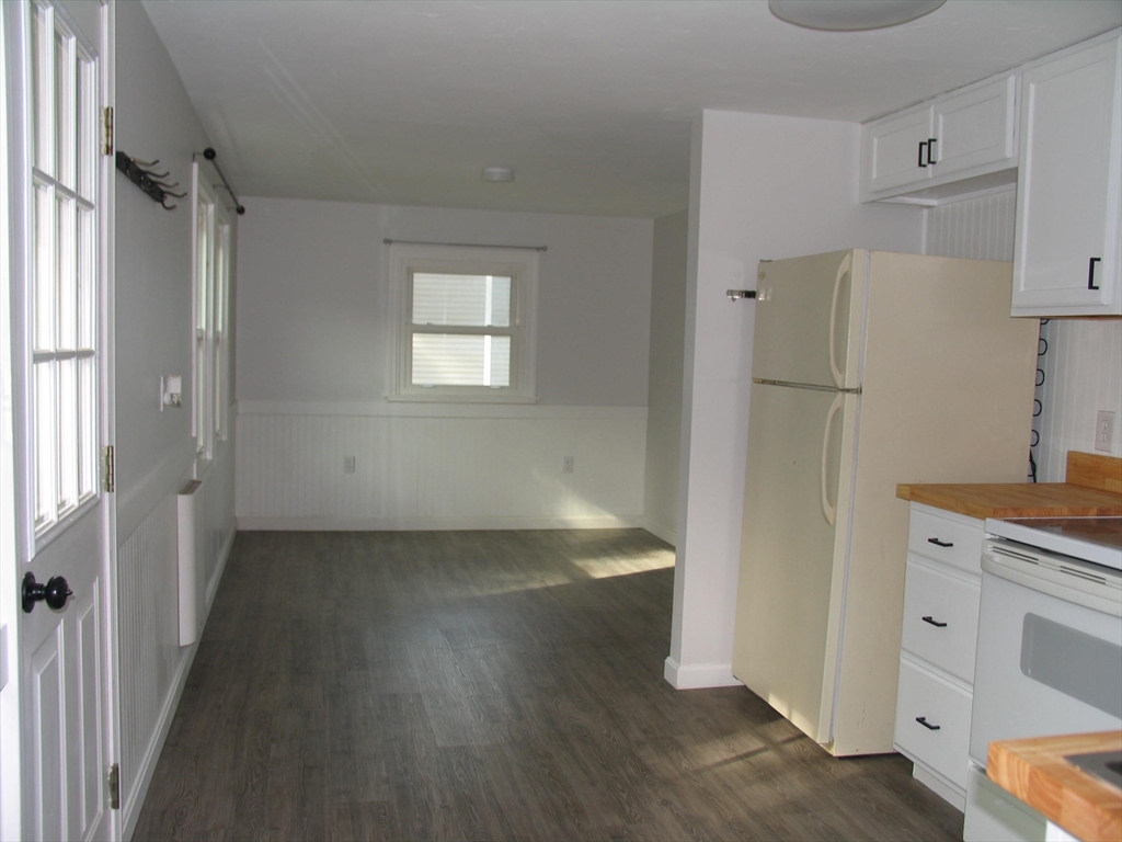 11 Black Point Road Webster, MA 01570 - Photo 10 of 28 a view of a kitchen with white cabinets and wooden floor