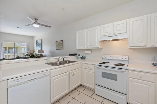 a kitchen with white cabinets stainless steel appliances and sink
