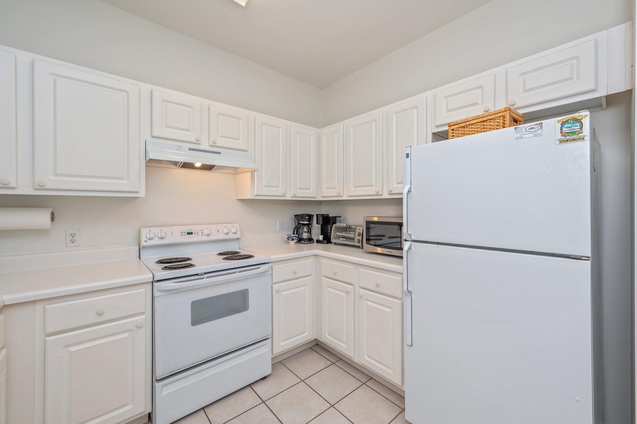 34 Heron's Watch Way, Unit 2303 Santa Rosa Beach, FL 32459 - Photo 16 of 45 a white refrigerator freezer sitting in a kitchen