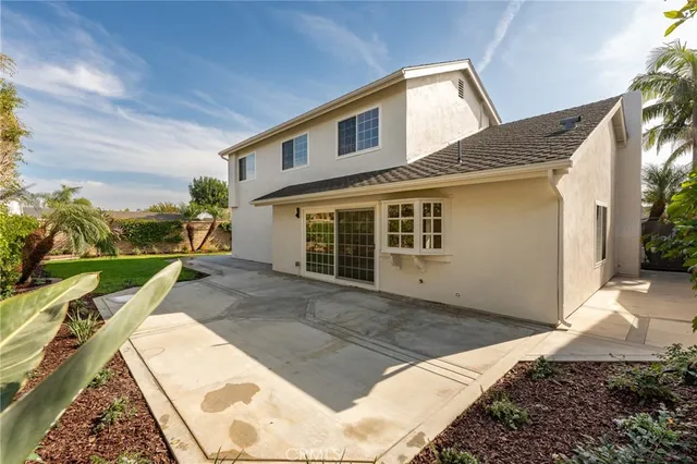 a view of a house with swimming pool and sitting area