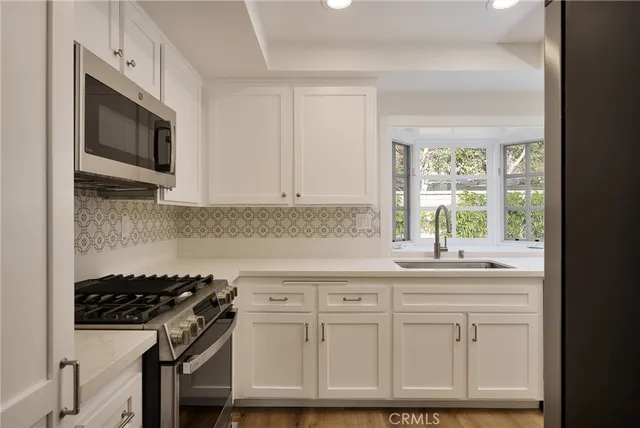a kitchen with a sink and a refrigerator