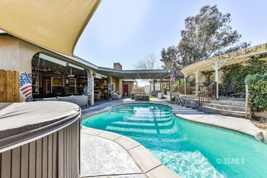1213 Carolyn Street Ridgecrest, CA 93555 - Photo 46 of 50 a view of a patio with a table chairs and a yard
