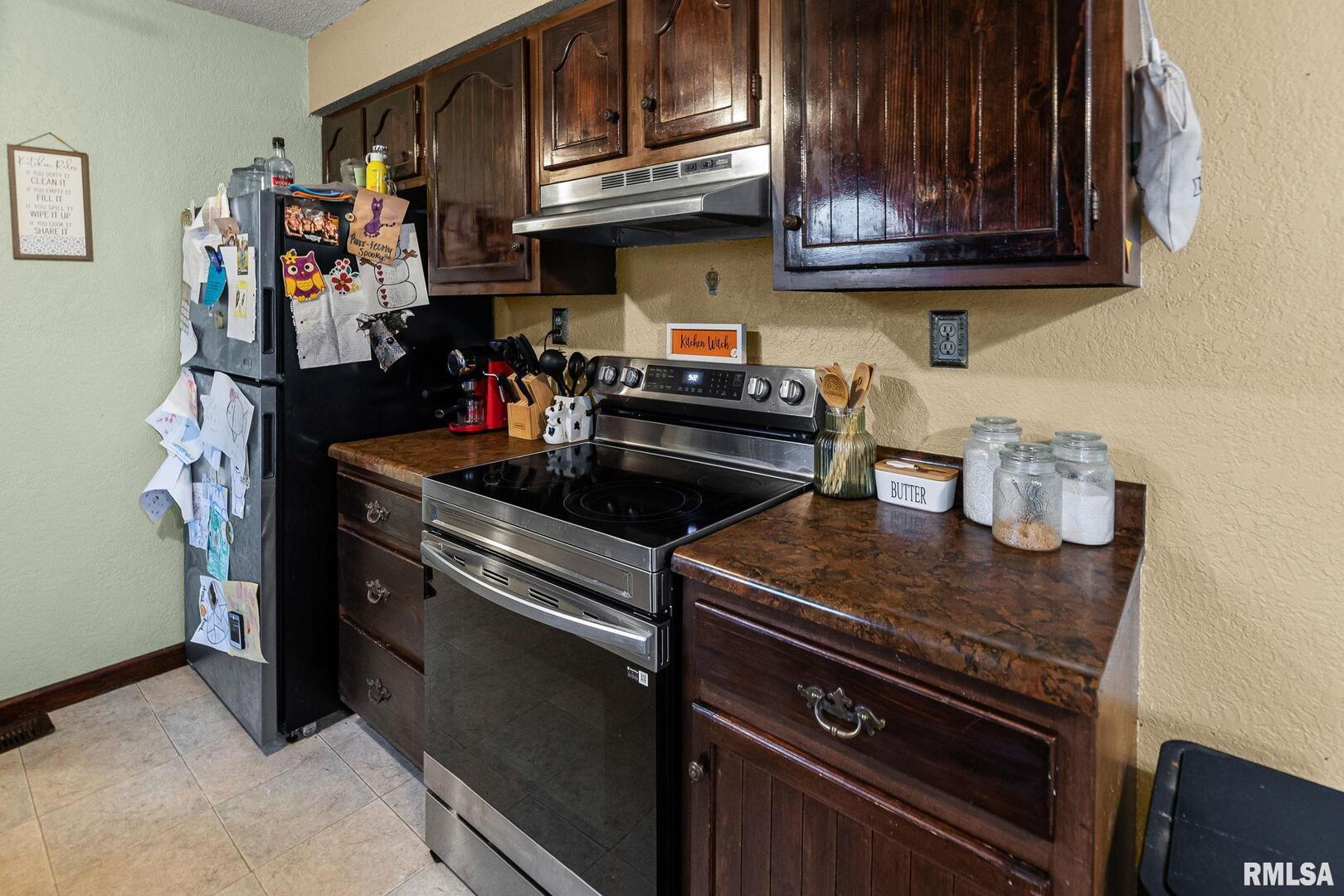 103 Middleton Street Iuka, IL 62849 - Photo 13 of 27 a kitchen with stainless steel appliances granite countertop a stove and a microwave