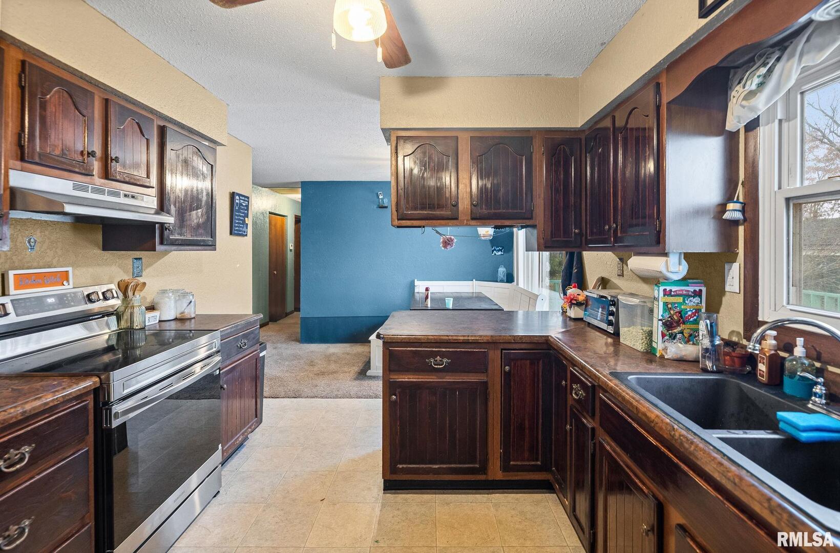 103 Middleton Street Iuka, IL 62849 - Photo 18 of 27 a kitchen with a stove sink and cabinets