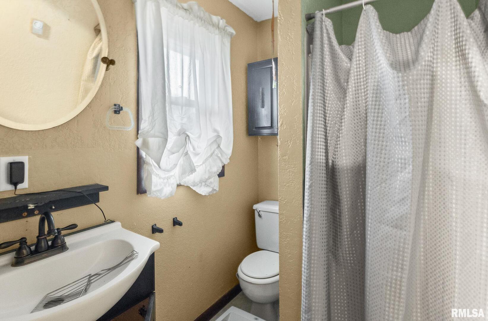 103 Middleton Street Iuka, IL 62849 - Photo 27 of 27 a bathroom with a sink toilet and a mirror