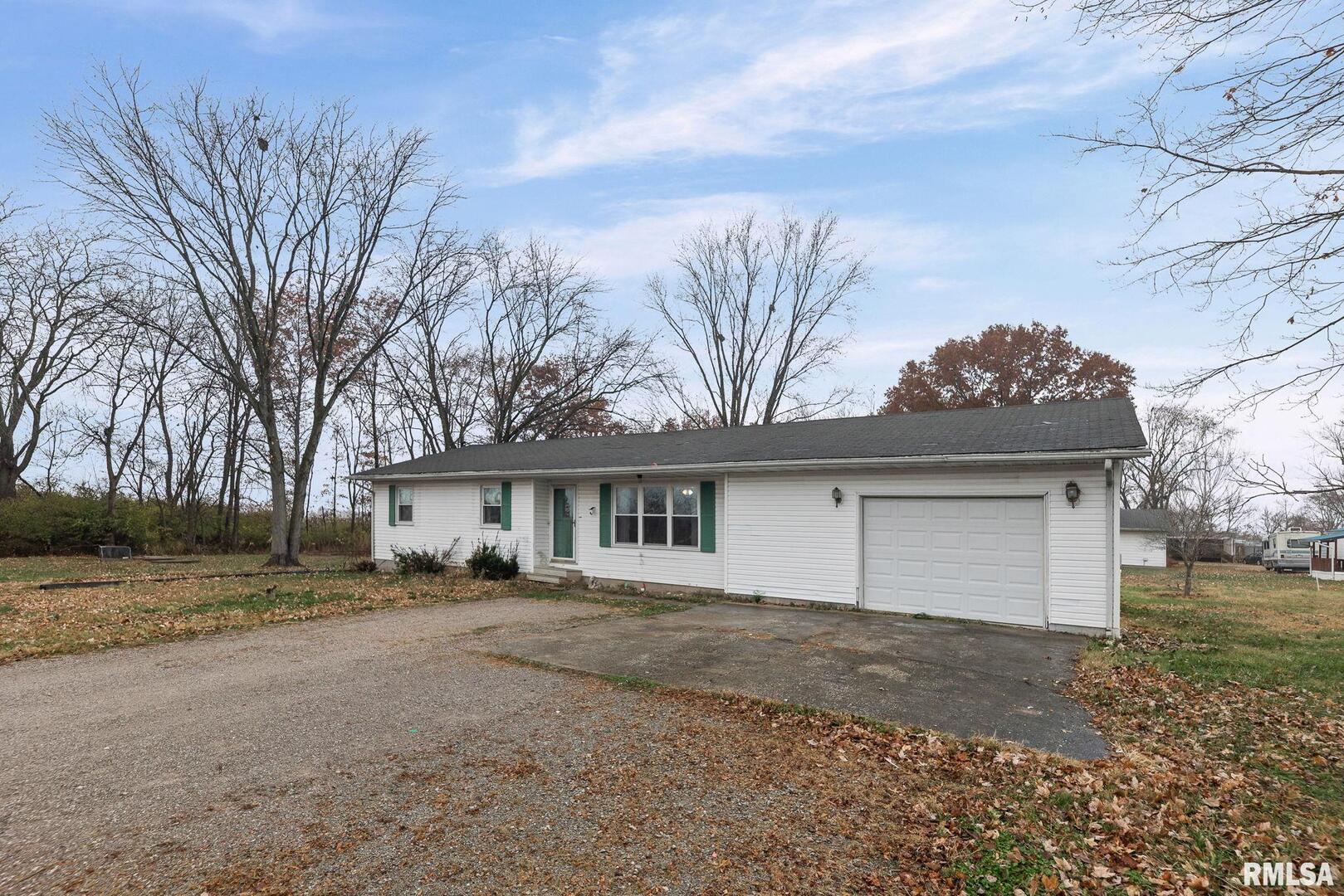 103 Middleton Street Iuka, IL 62849 - Photo 3 of 27 a front view of a house with a yard and garage