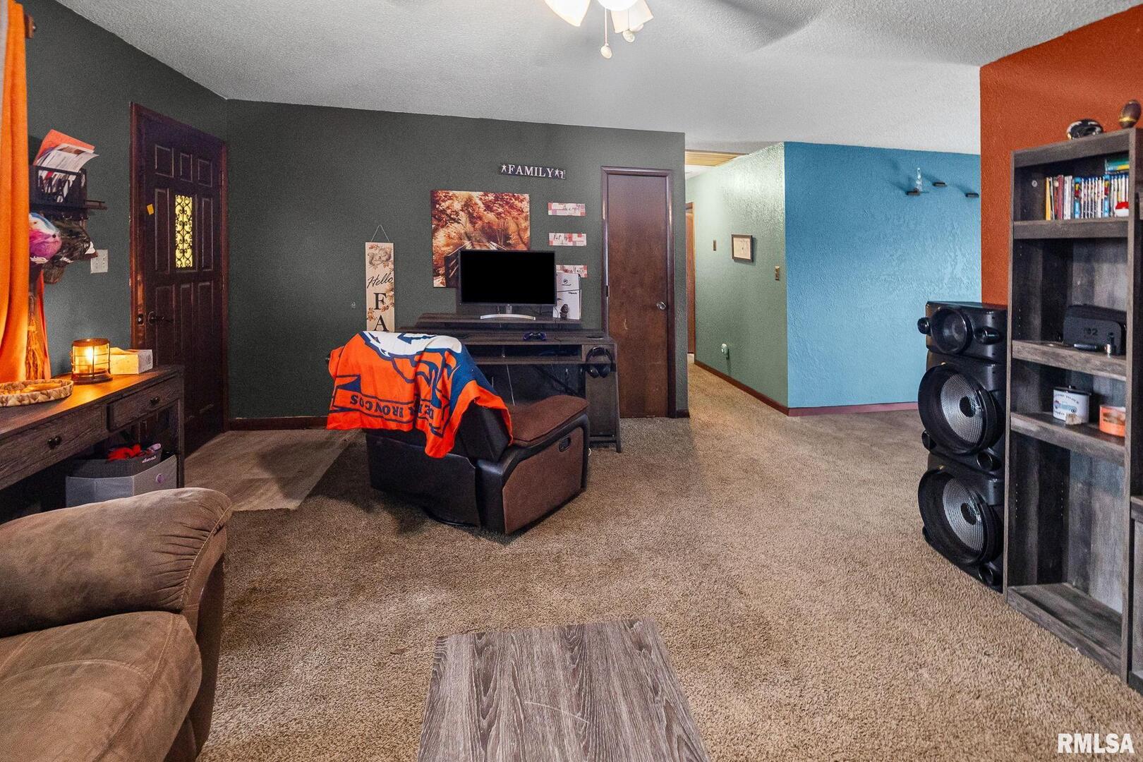 103 Middleton Street Iuka, IL 62849 - Photo 10 of 27 a living room with furniture and a flat screen tv