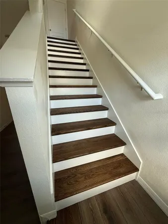 a bathroom with a granite countertop sink a toilet and shower