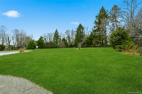 a front view of a house with a yard covered in snow