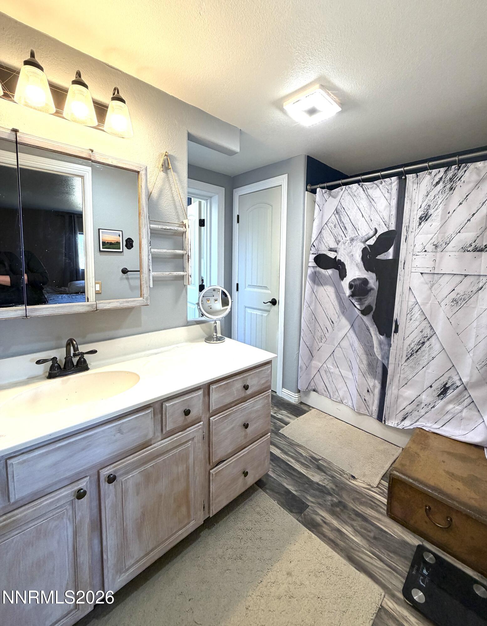 5 Rhoda Lane Yerington, NV 89447 - Photo 15 of 27 a spacious bathroom with a double vanity sink and a mirror