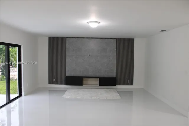 a kitchen with a sink and a mirror